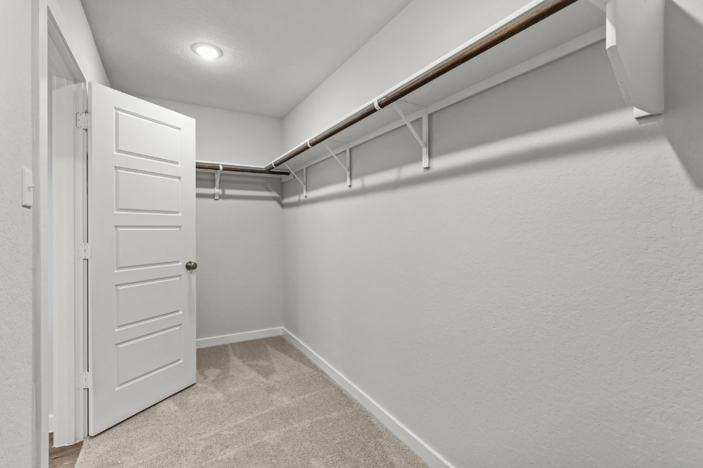 A white hallway with white doors.