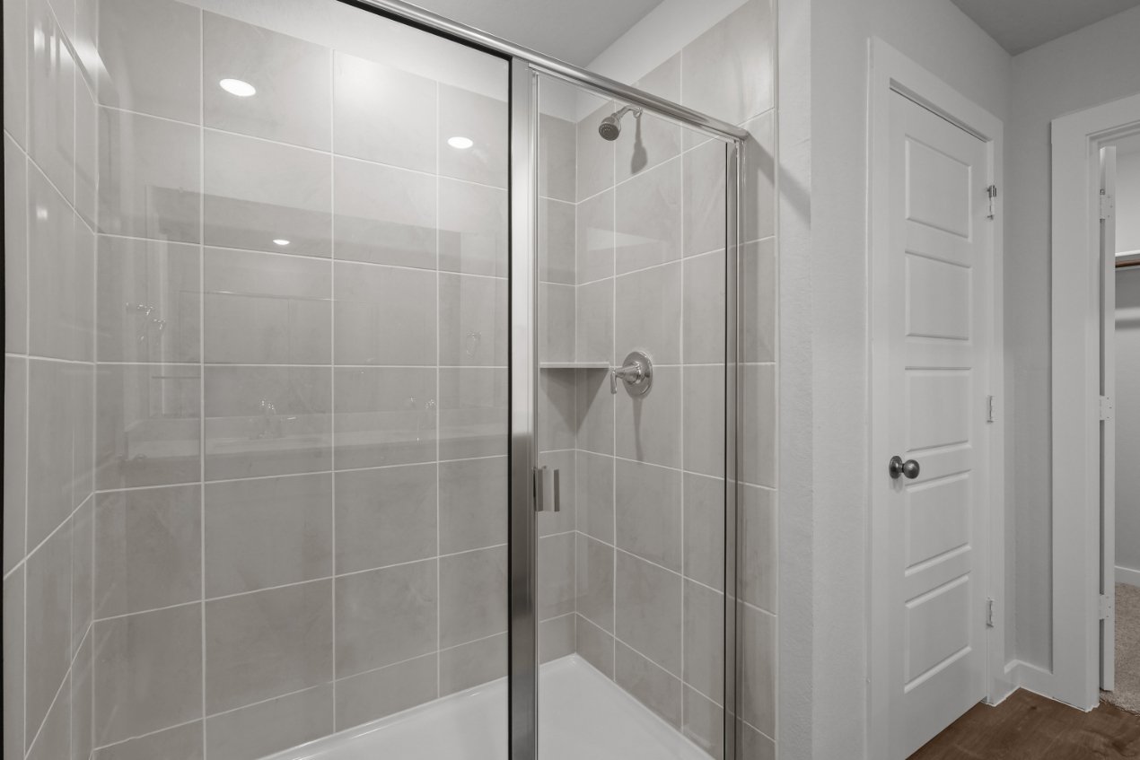 A shower with a glass door.
