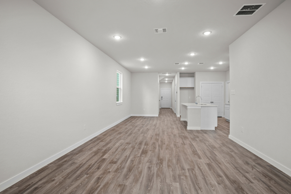 A long hallway with white walls.