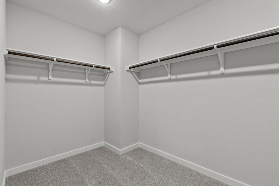 A white wall with a metal railing.