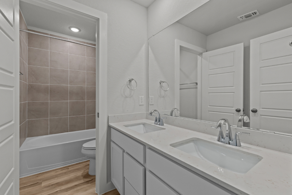 A bathroom with a tub sink and toilet.