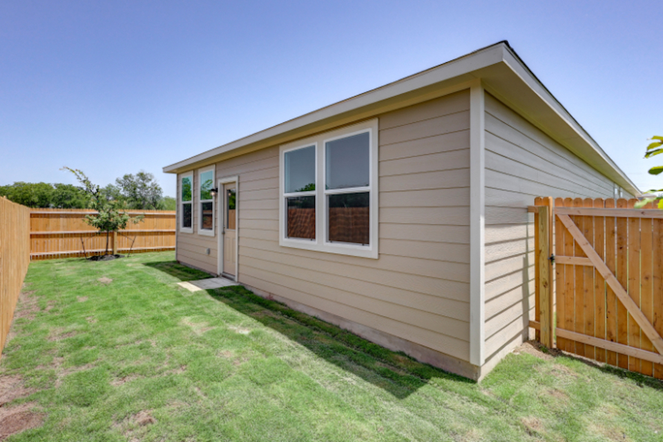 A small house with a fence.