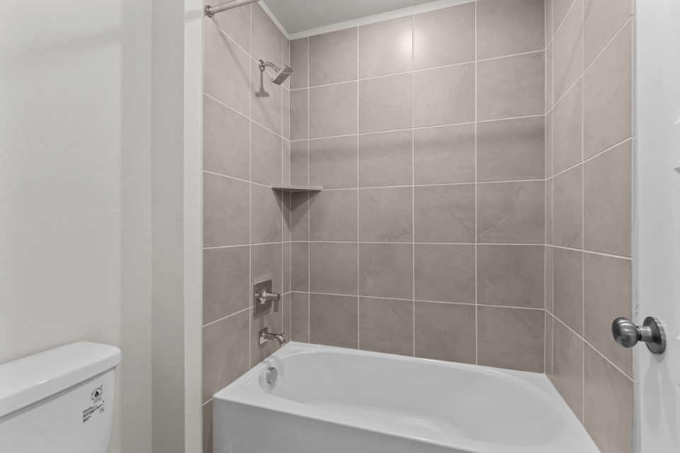 A bathtub in a bathroom.