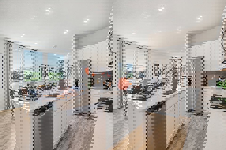 A kitchen with white cabinets.