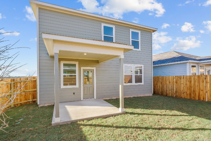 A house with a fence and grass.