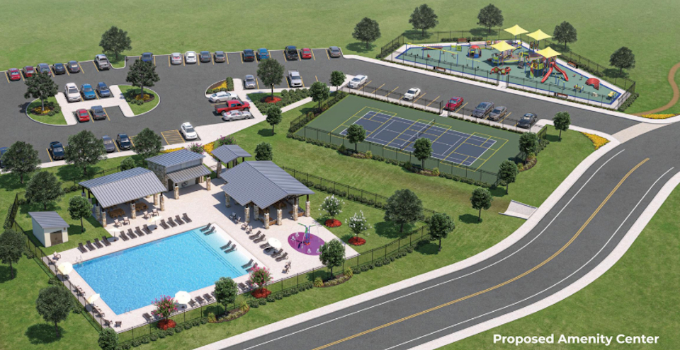 A swimming pool with a few cars parked in the background.