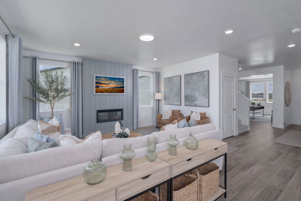 A living room with a large glass table and a large white couch.