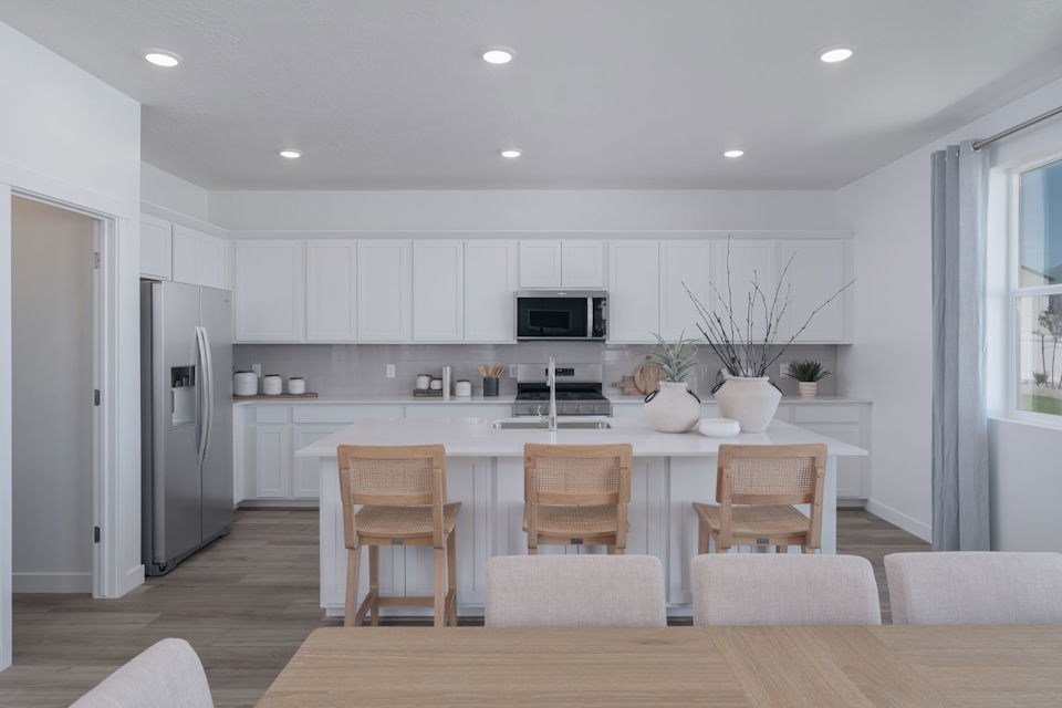 A kitchen with white cabinets.