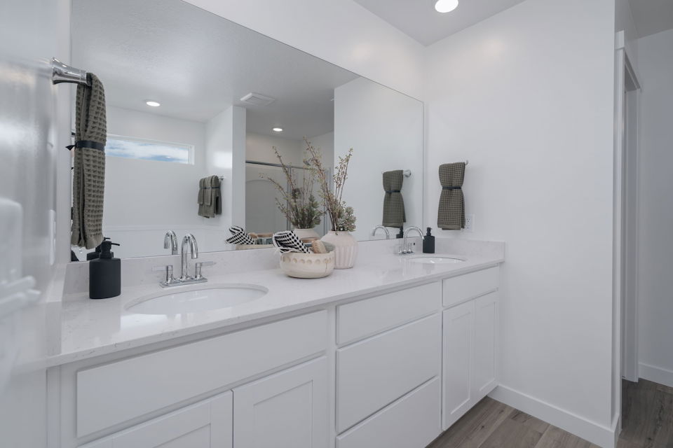 A bathroom with a large mirror.