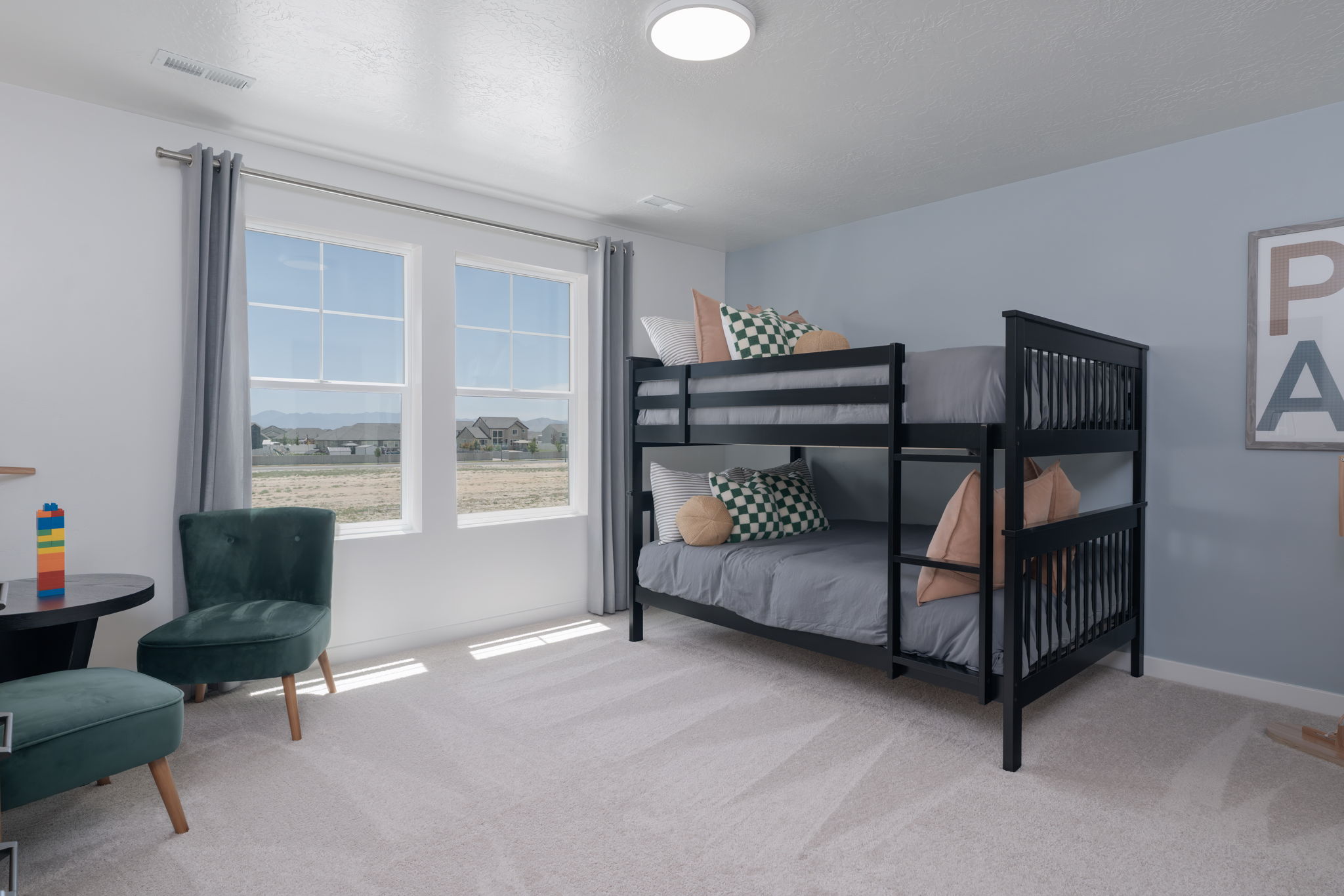 A bedroom with a bed and a chair.