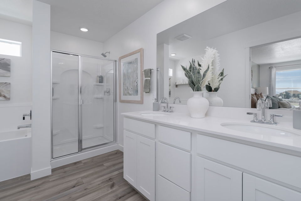 A bathroom with white cabinets.