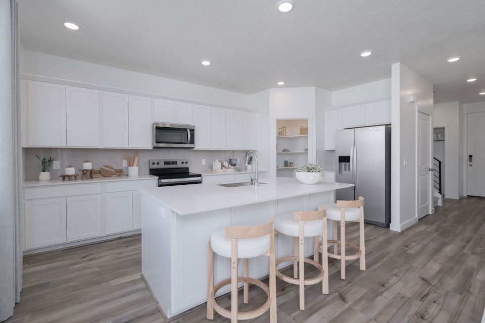 A kitchen with white cabinets.