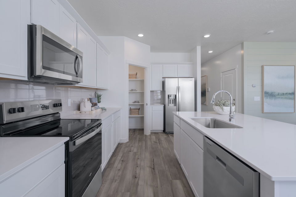 A kitchen with white cabinets.