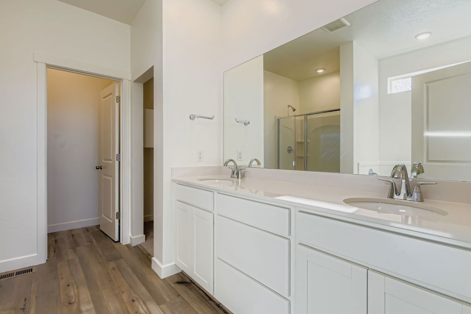 A bathroom with white cabinets.
