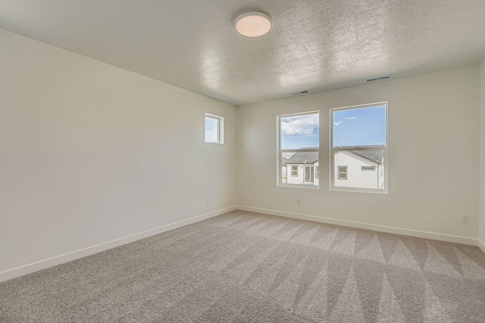A room with a window and a carpet.