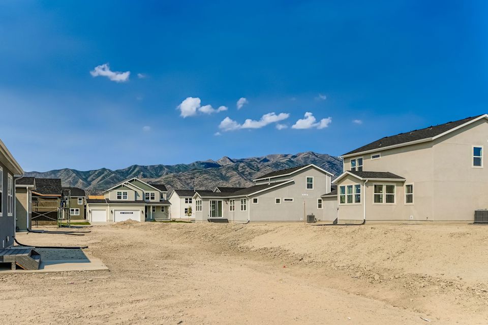 A group of houses in a sandy area.
