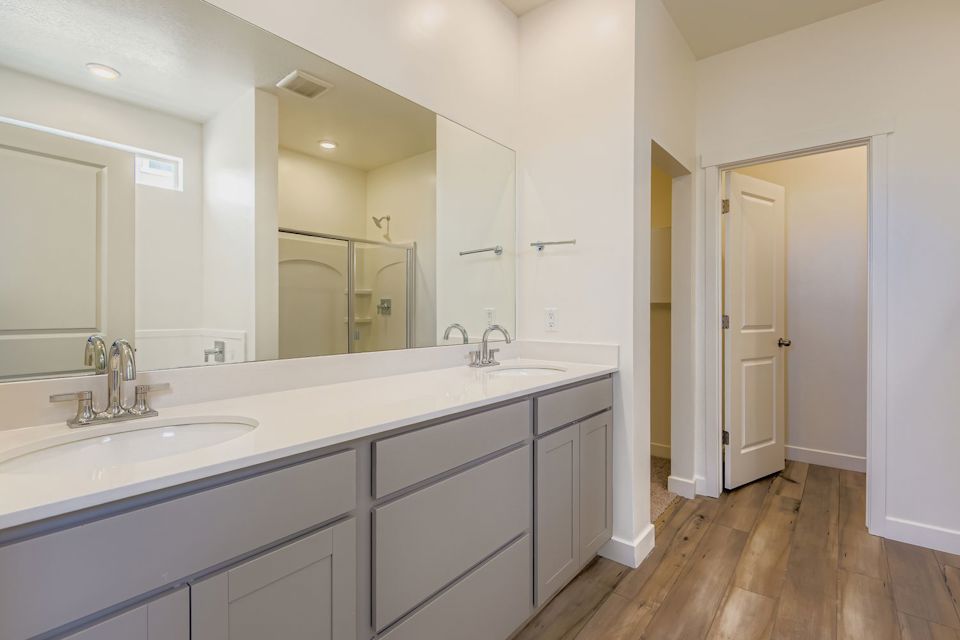 A bathroom with a large mirror.