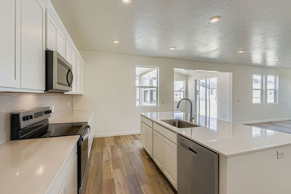 A kitchen with white cabinets.