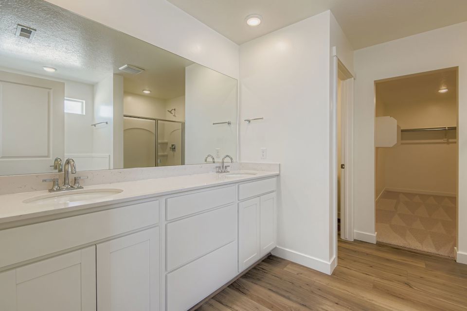 A bathroom with white cabinets.