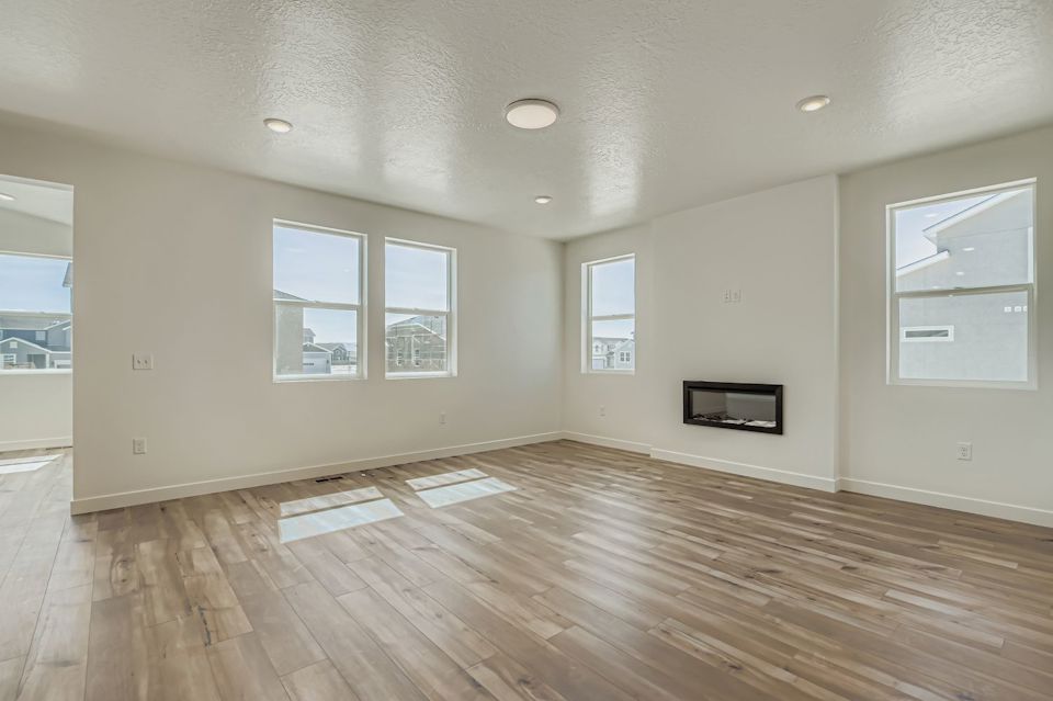 A room with a wood floor and white walls.