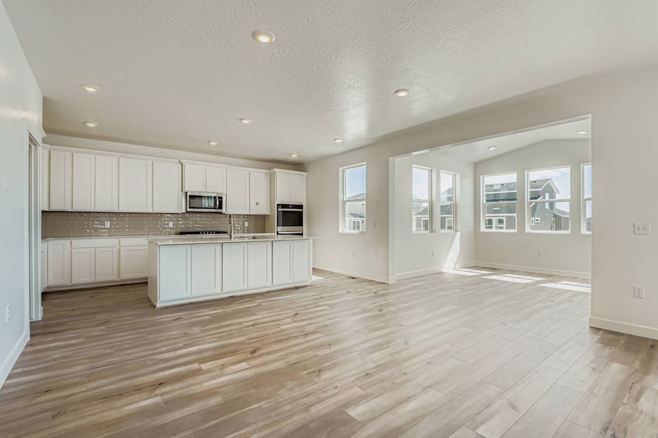 A large kitchen with white cabinets.