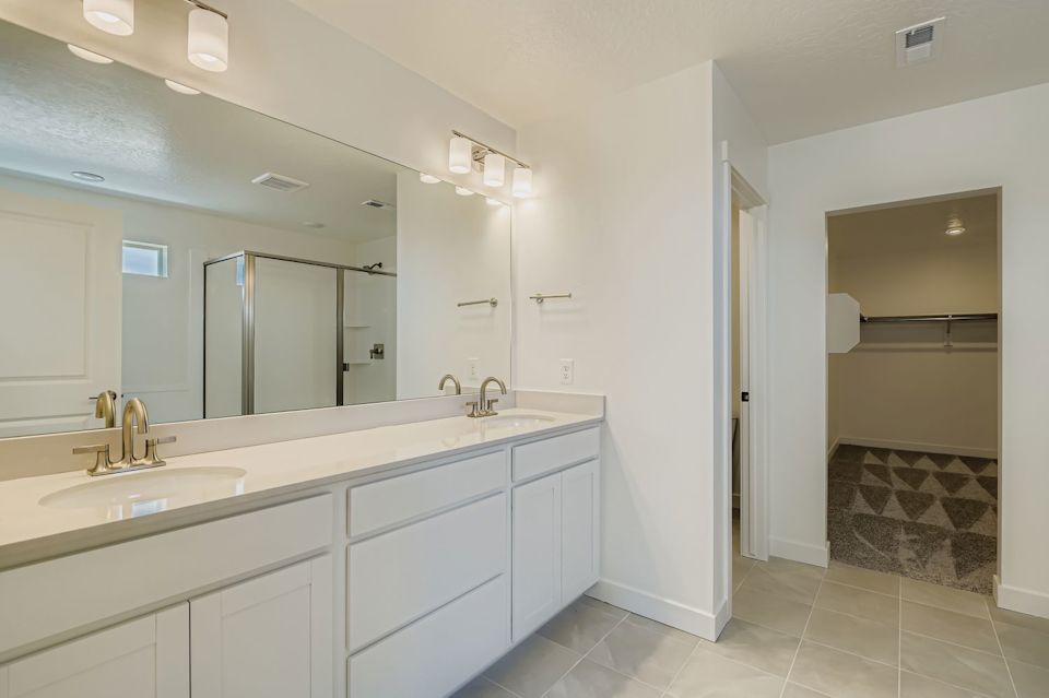 A bathroom with white cabinets.