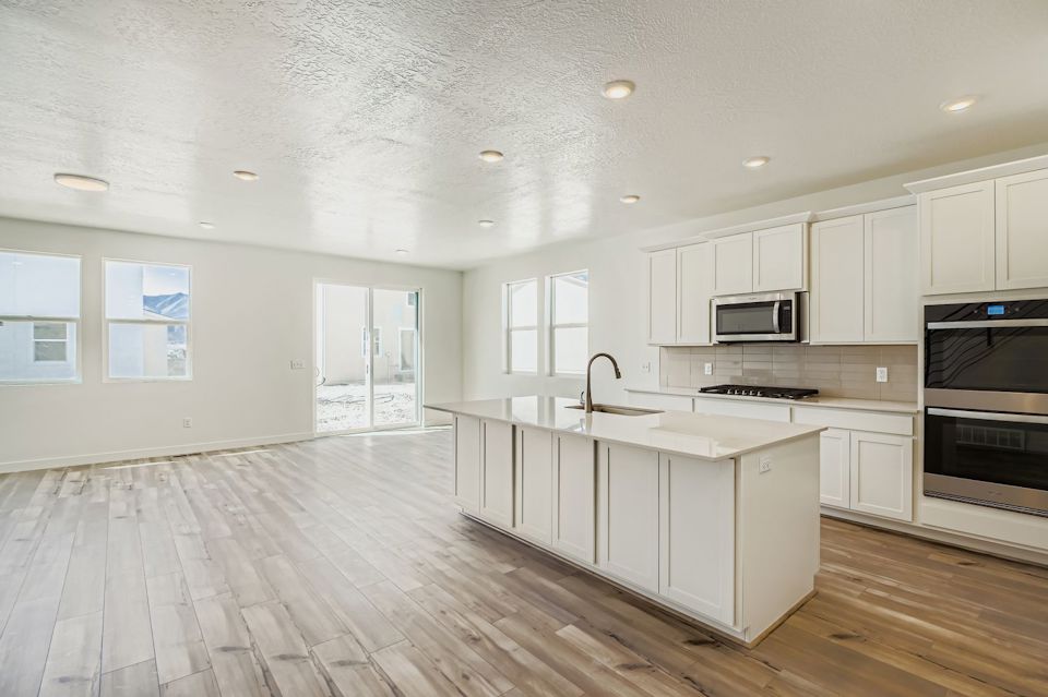 A kitchen with white cabinets.