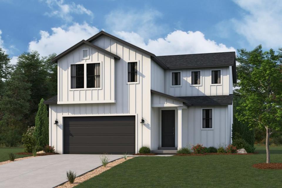 A white house with a garage.