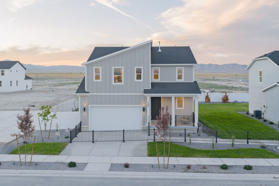 A white house with a black fence.