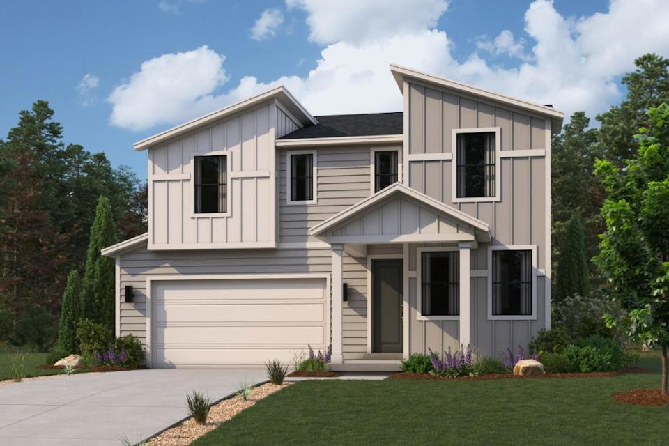 A white house with a lawn.