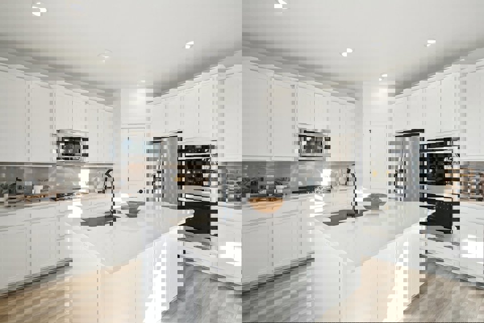 A kitchen with white cabinets.