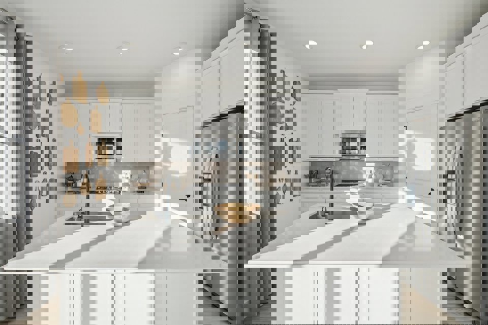 A kitchen with white cabinets.