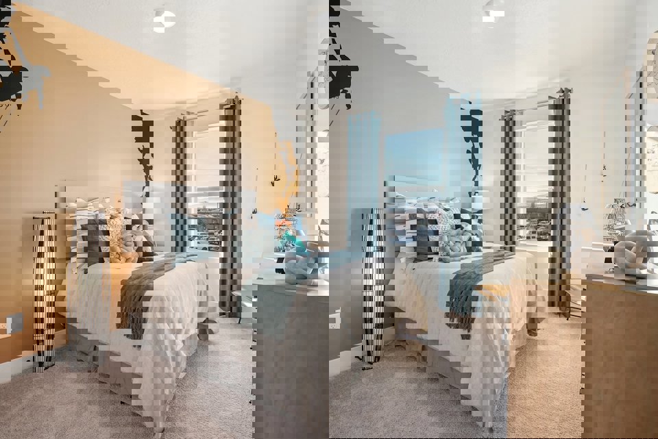 A bedroom with a bed and a desk.