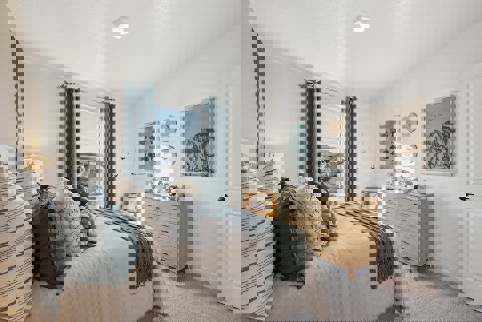 A bedroom with a bed and a window.