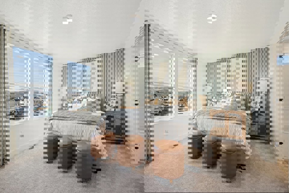 A bedroom with a large window.