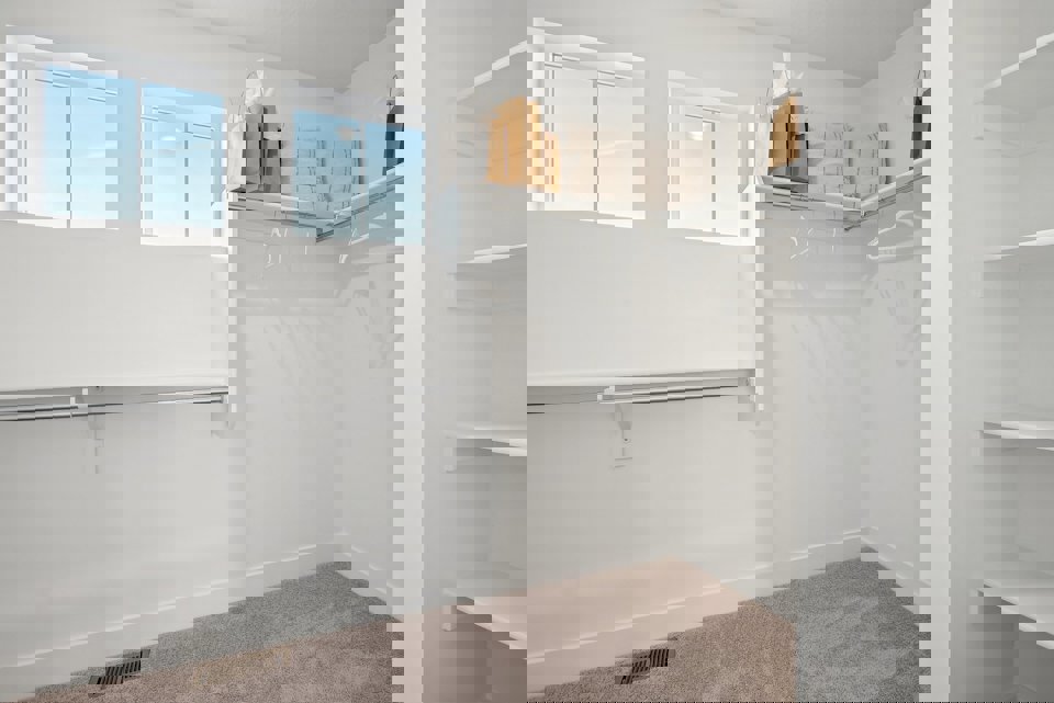 A bathroom with a shelf and towels.