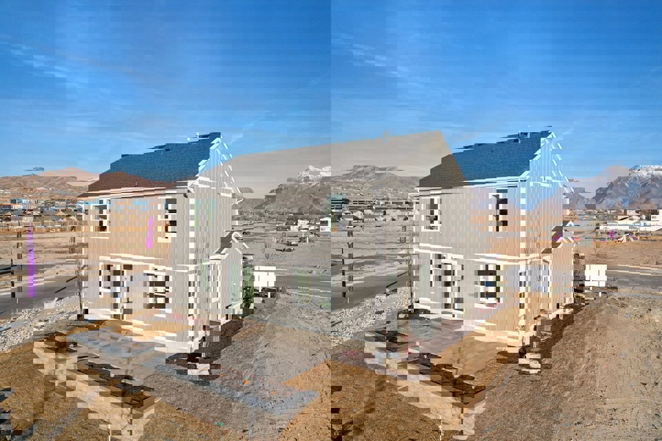 A white house in a dirt field.