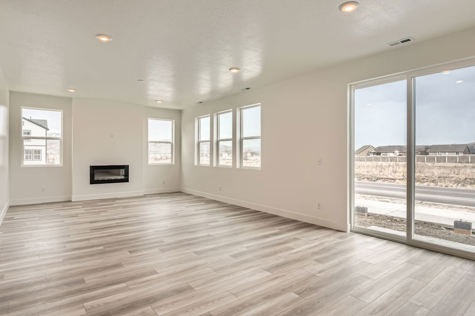 A room with windows and a wood floor.