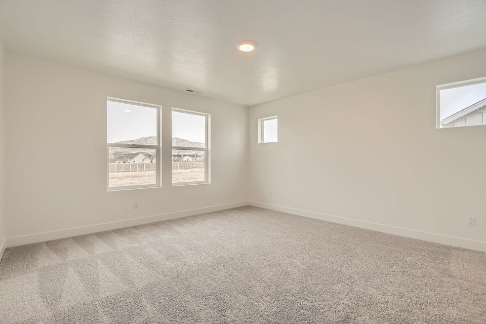 A room with a window and a view of a city.