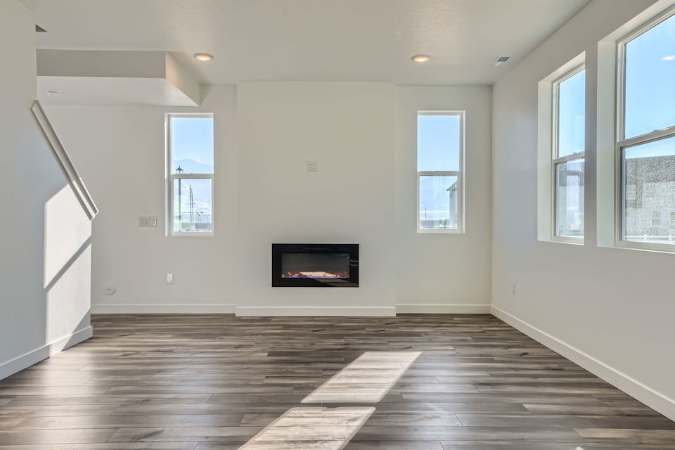 A room with a tv and windows.