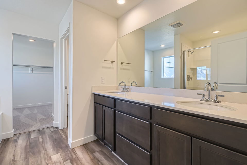 A bathroom with a large mirror.