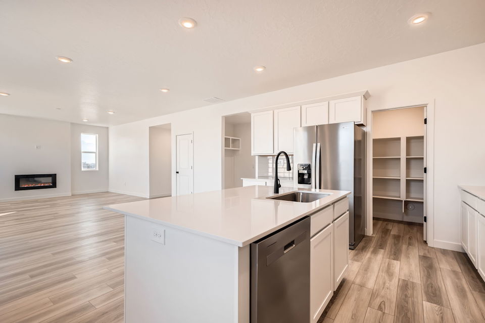 A kitchen with white cabinets.