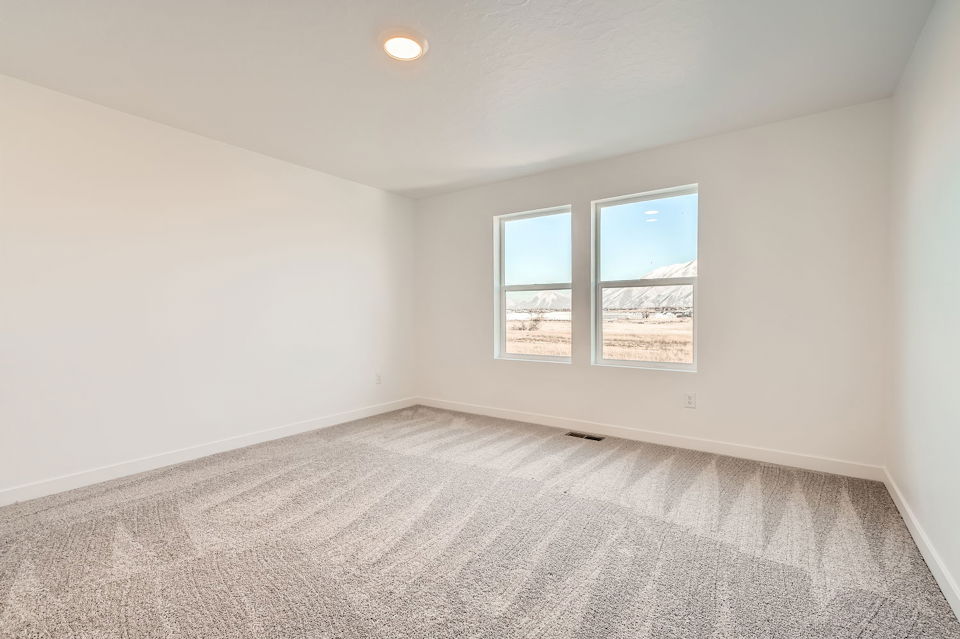 A room with a window and a carpet.