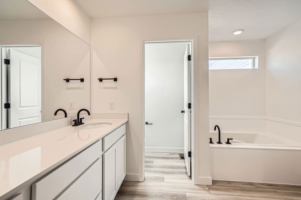 A bathroom with a tub sink and a bathtub.