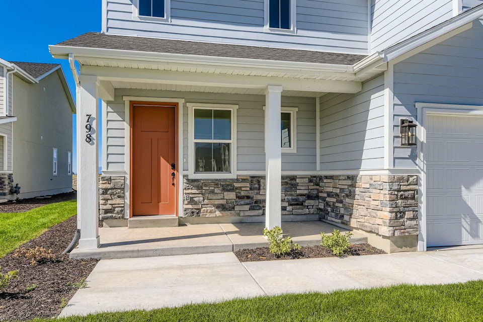 A house with a stone patio.