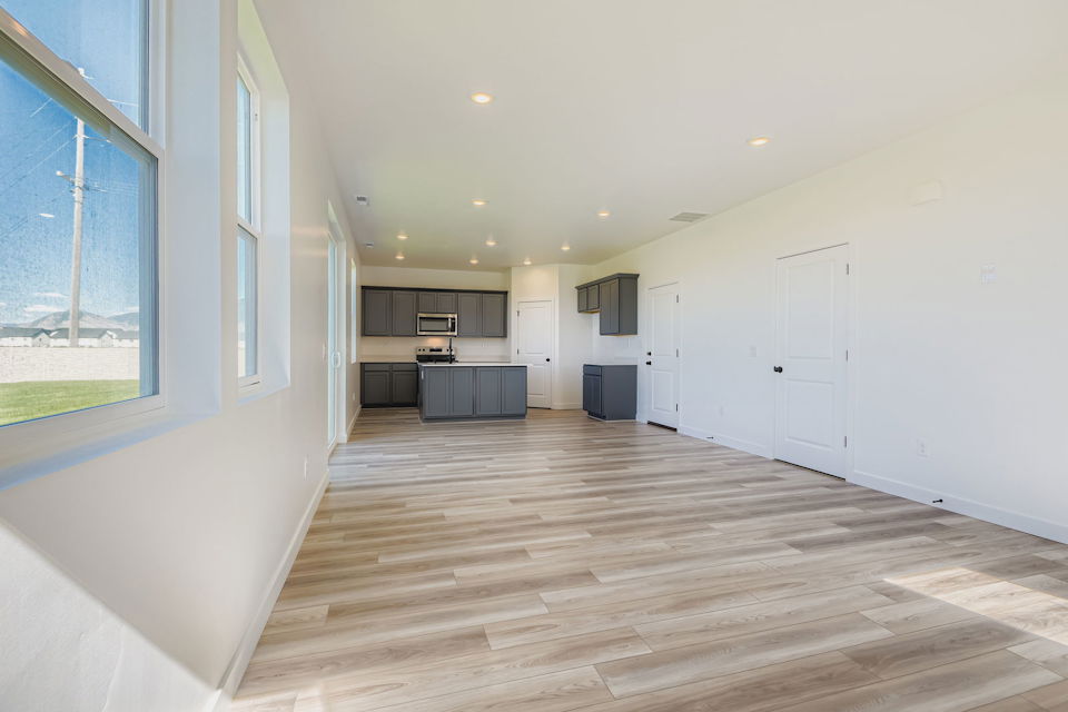 A room with white walls and wood floors.