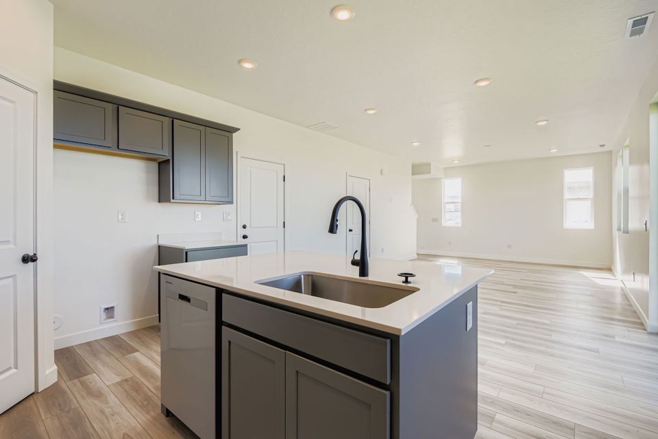 A kitchen with a sink and cabinets.