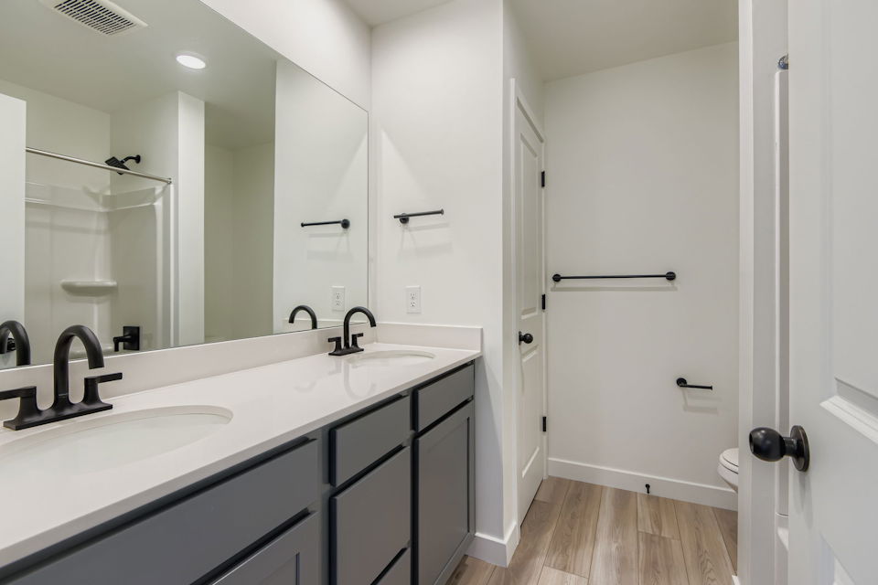 A bathroom with a large mirror.