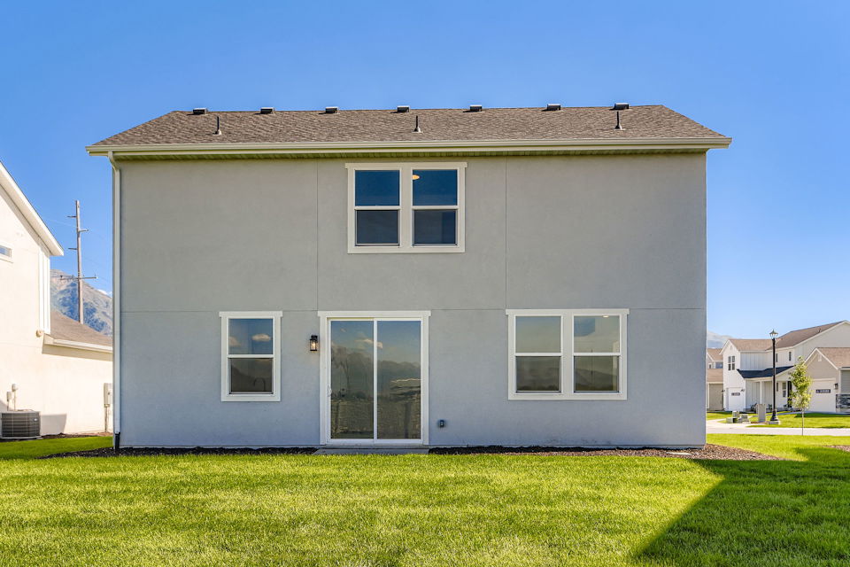 A small building with a grass yard.