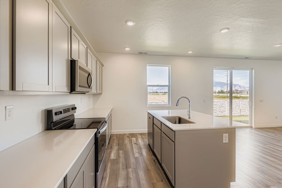 A kitchen with white cabinets.